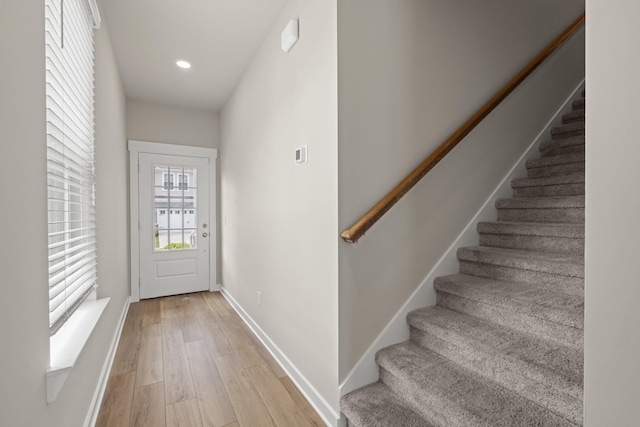 entryway featuring stairway, baseboards, recessed lighting, and light wood-style flooring