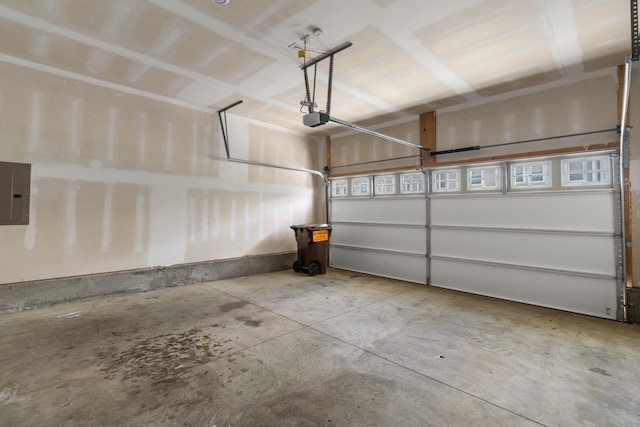 garage with a garage door opener and electric panel