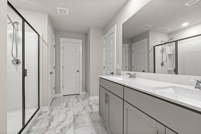 bathroom featuring visible vents, a sink, marble finish floor, and a shower stall