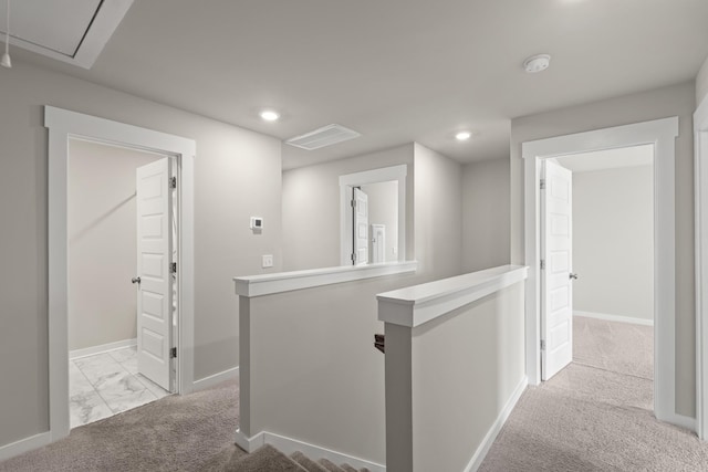 hall featuring carpet floors, baseboards, attic access, recessed lighting, and an upstairs landing