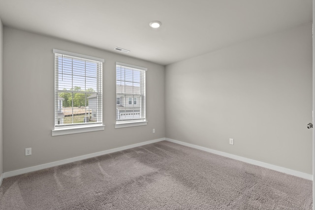 unfurnished room with baseboards, carpet, recessed lighting, and visible vents
