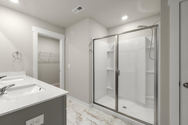 bathroom with visible vents, a sink, marble finish floor, and a shower stall