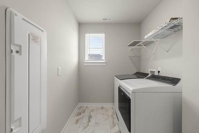 laundry room featuring visible vents, laundry area, marble finish floor, a heating unit, and independent washer and dryer
