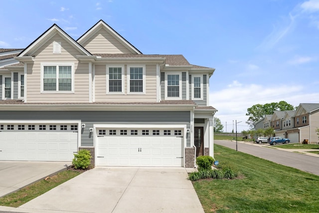 view of property with concrete driveway, an attached garage, and a front lawn