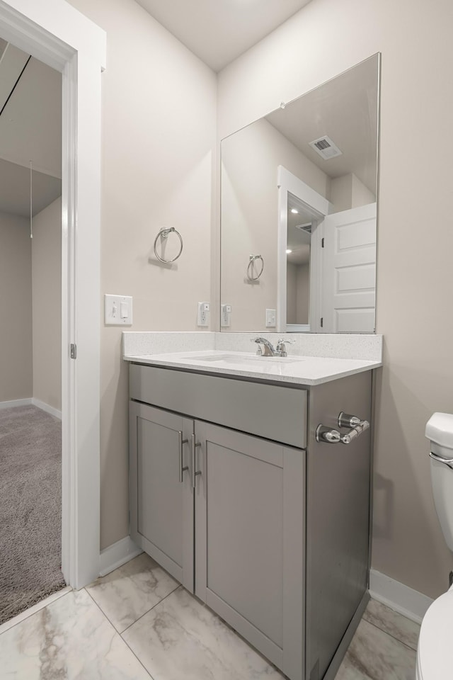 bathroom featuring baseboards, marble finish floor, toilet, and visible vents