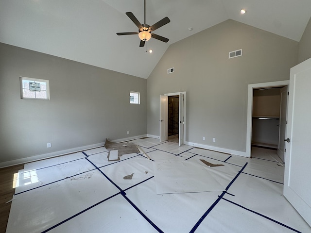 unfurnished bedroom with ceiling fan, high vaulted ceiling, visible vents, and baseboards