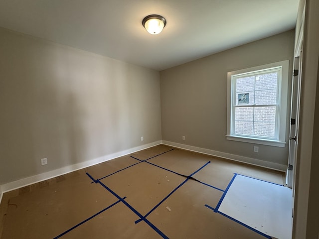 spare room featuring baseboards