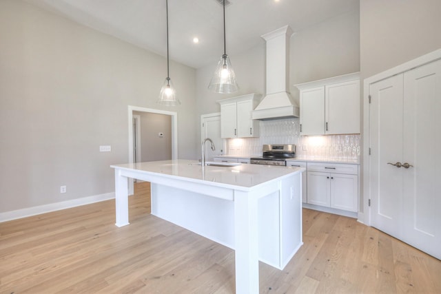 4020 Runyan Cv, Murfreesboro, TN 37127 - kitchen featuring custom range hood, stainless steel electric range, backsplash, a center island with sink, and high vaulted ceiling