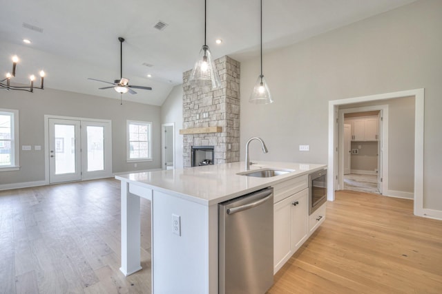 4020 Runyan Cv, Murfreesboro, TN 37127 - kitchen featuring stainless steel appliances, open floor plan, an island with sink, a stone fireplace, and a ceiling fan
