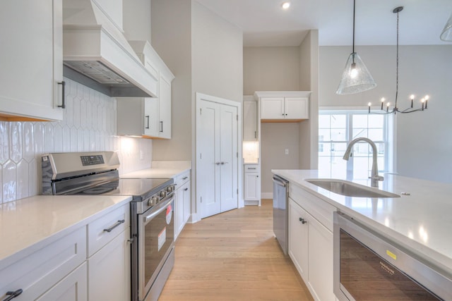 4020 Runyan Cv, Murfreesboro, TN 37127 - kitchen featuring appliances with stainless steel finishes, premium range hood, light wood-style floors, decorative backsplash, and pendant lighting