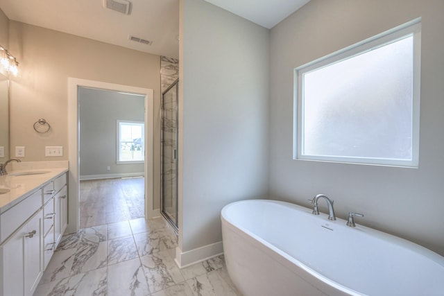 4020 Runyan Cv, Murfreesboro, TN 37127 - bathroom featuring marble look tile flooring, a freestanding bath, double vanity, and an enclosed shower
