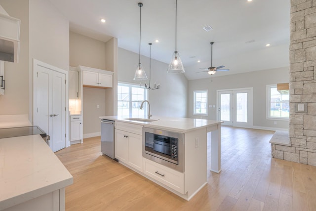 4020 Runyan Cv, Murfreesboro, TN 37127 - kitchen with stainless steel appliances, light wood-style flooring, a ceiling fan, white cabinets, and high vaulted ceiling