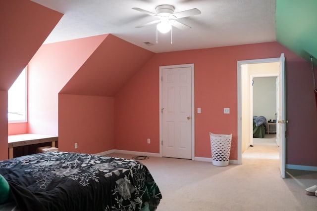bedroom with light colored carpet, a ceiling fan, baseboards, lofted ceiling, and visible vents