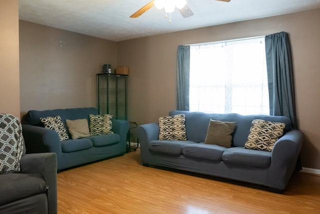 living room featuring ceiling fan and wood finished floors