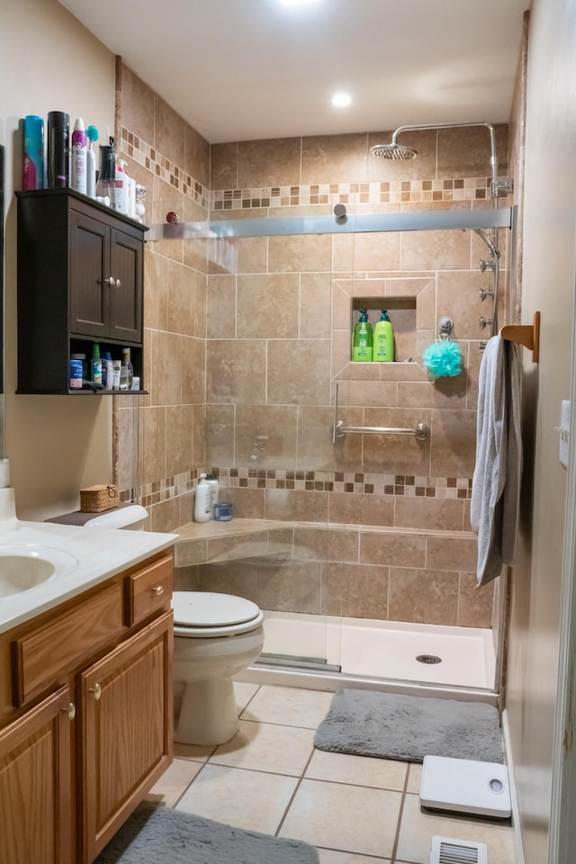 full bathroom with vanity, tile patterned floors, a stall shower, and toilet