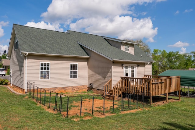 rear view of house with a lawn, crawl space, a wooden deck, and a shingled roof