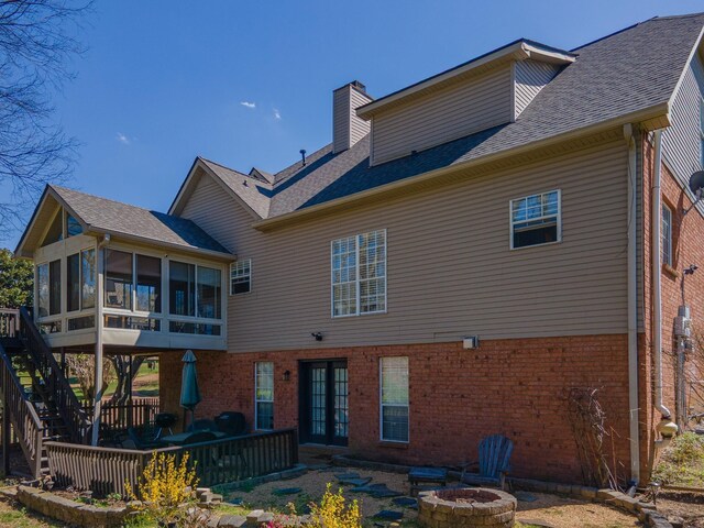 1408 Ridley Dr, Franklin, TN 37064 - rear view of property with an outdoor fire pit, a sunroom, brick siding, and a chimney