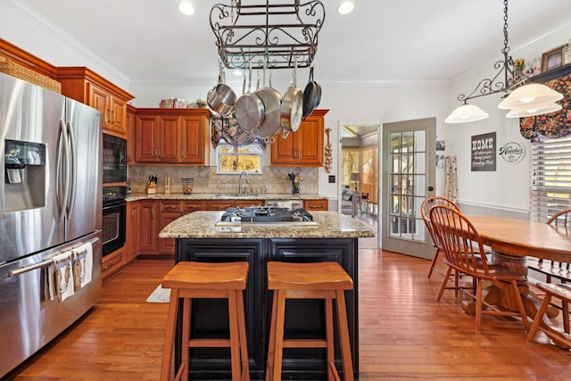 1408 Ridley Dr, Franklin, TN 37064 - kitchen featuring black appliances, a chandelier, plenty of natural light, crown molding, and decorative backsplash