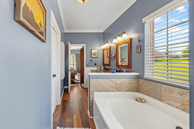 1408 Ridley Dr, Franklin, TN 37064 - full bath featuring hardwood / wood-style flooring, a garden tub, ornamental molding, and double vanity