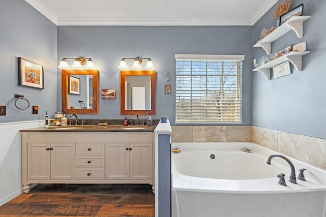 1408 Ridley Dr, Franklin, TN 37064 - bathroom featuring a garden tub, crown molding, double vanity, wood finished floors, and wainscoting
