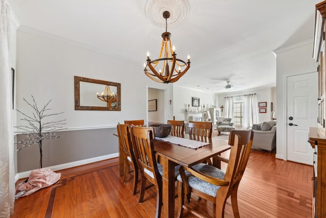 1408 Ridley Dr, Franklin, TN 37064 - dining room with a chandelier, wood-type flooring, crown molding, ceiling fan, and baseboards
