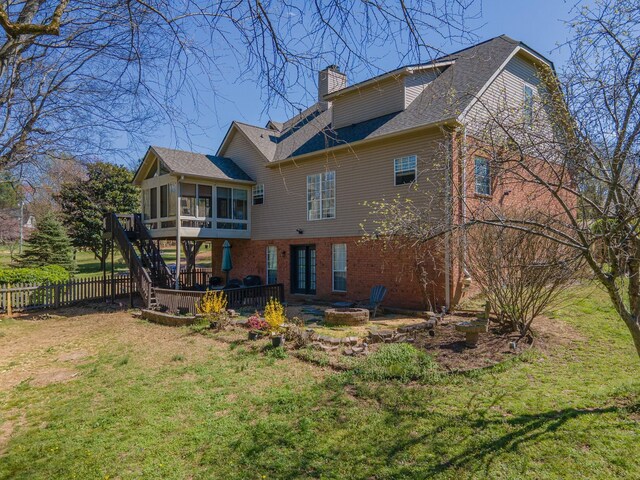 1408 Ridley Dr, Franklin, TN 37064 - back of house featuring a sunroom, a fire pit, a chimney, brick siding, and a shingled roof
