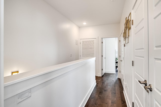 corridor featuring recessed lighting, baseboards, and dark wood-style flooring