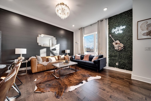 living room with wood finished floors, baseboards, a chandelier, an accent wall, and recessed lighting