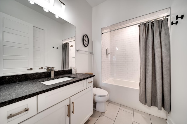 bathroom featuring tile patterned flooring, shower / tub combo, toilet, and vanity