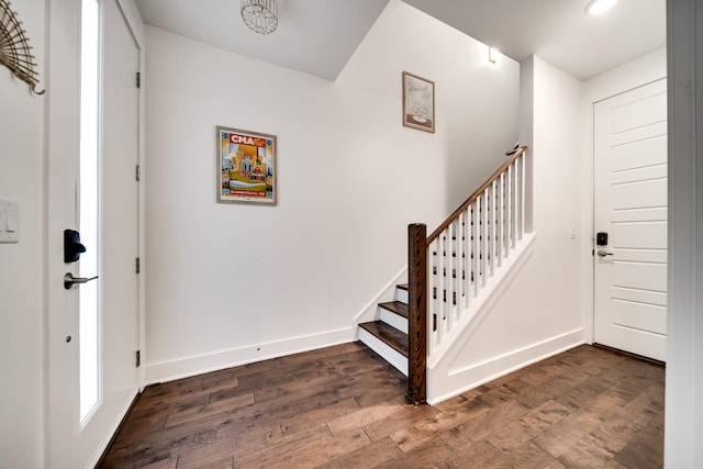 foyer entrance with dark wood-style flooring, baseboards, recessed lighting, and stairway