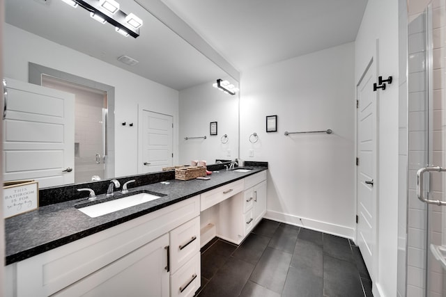 bathroom featuring double vanity, a sink, tile patterned floors, and a shower stall