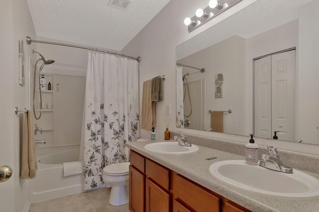 bathroom featuring toilet, visible vents, shower / bathtub combination with curtain, and a sink