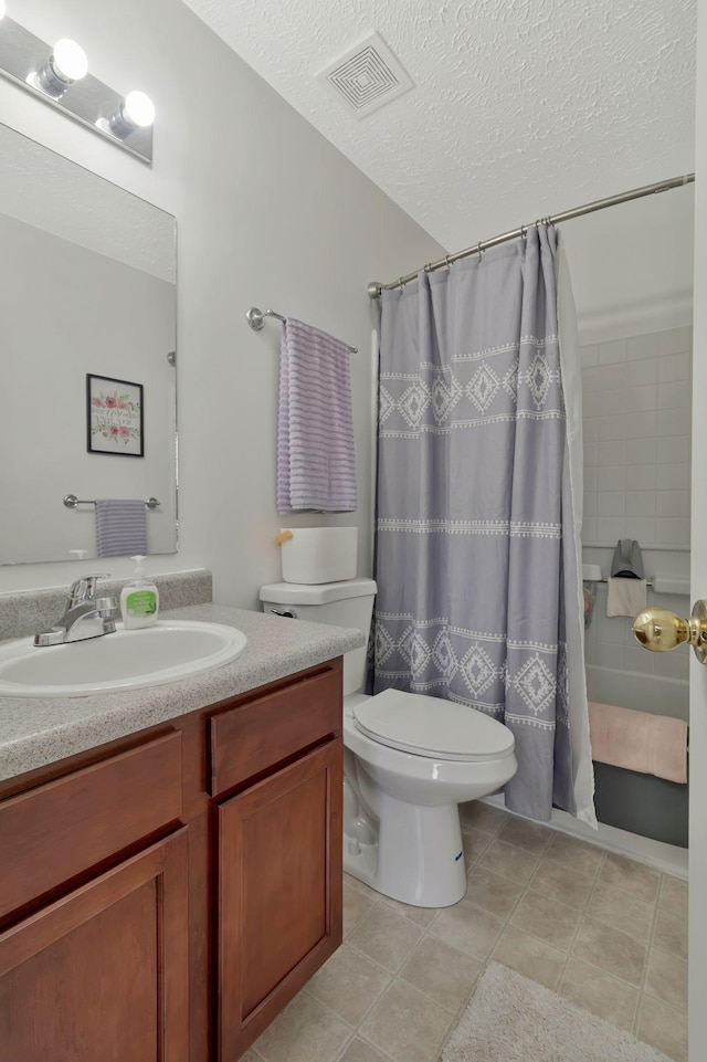 bathroom featuring visible vents, vanity, toilet, a textured ceiling, and a shower with curtain