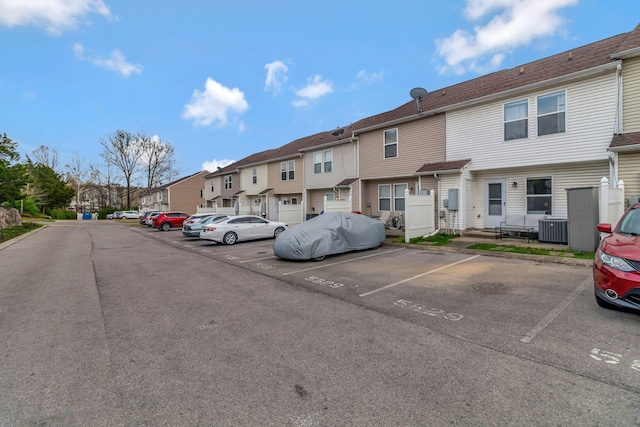 uncovered parking lot featuring a residential view
