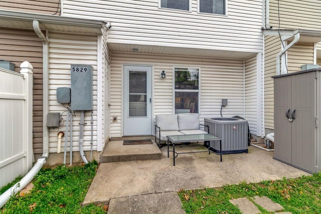 view of patio with an outdoor living space, central AC, and fence