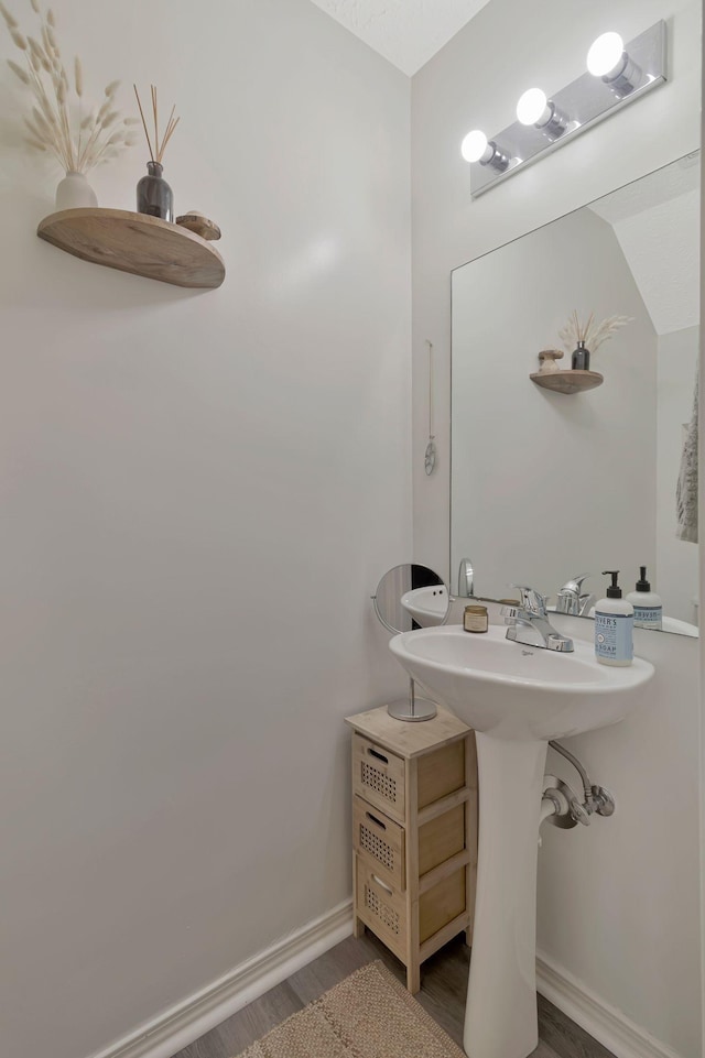 bathroom featuring baseboards and wood finished floors