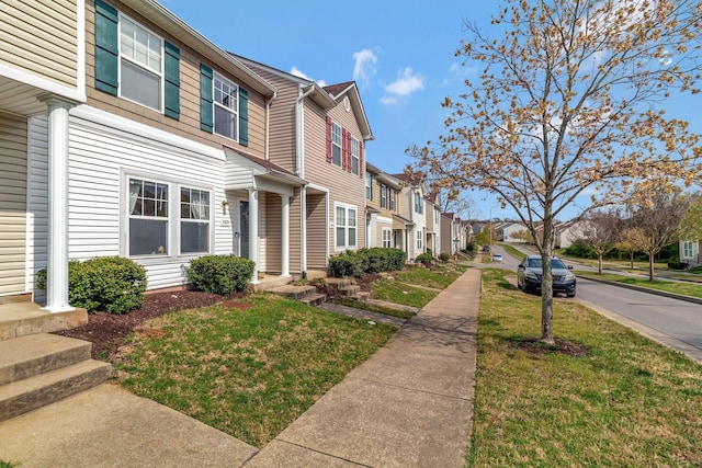 view of front facade with a residential view and a front lawn