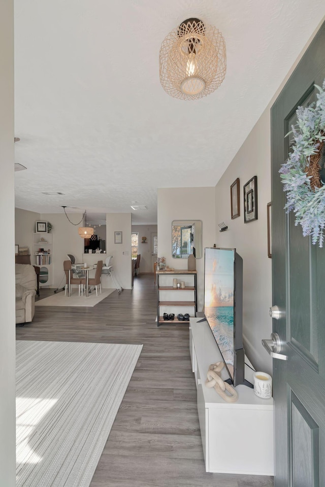 entrance foyer with baseboards and wood finished floors