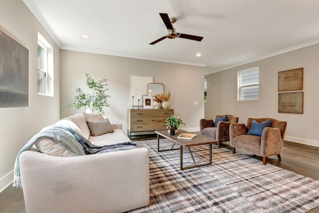 living room featuring baseboards, ceiling fan, a healthy amount of sunlight, and wood finished floors