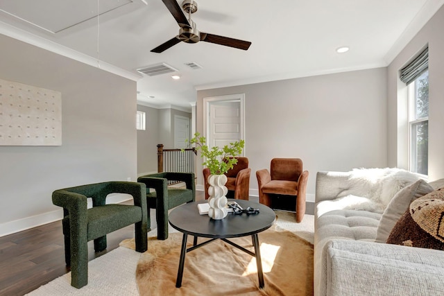 living area featuring ceiling fan, light wood-style flooring, attic access, baseboards, and visible vents
