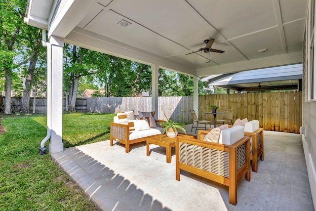 view of patio / terrace featuring a fenced backyard, a ceiling fan, and an outdoor living space