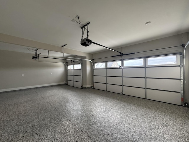 garage featuring baseboards and a garage door opener