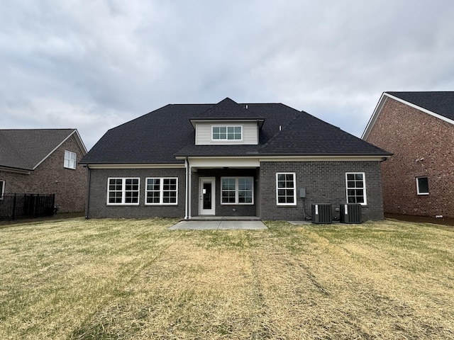 back of house featuring brick siding, a patio area, central air condition unit, and a yard