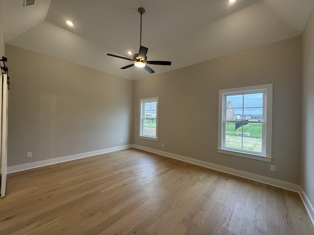 unfurnished room featuring a ceiling fan, baseboards, recessed lighting, wood finished floors, and vaulted ceiling