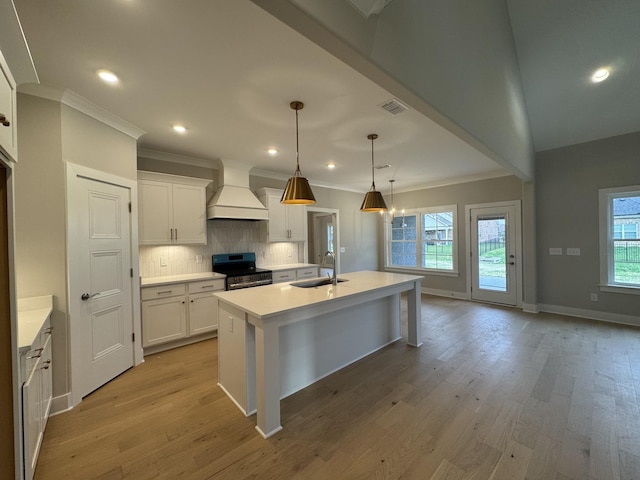 kitchen with visible vents, crown molding, custom exhaust hood, and stainless steel electric range oven