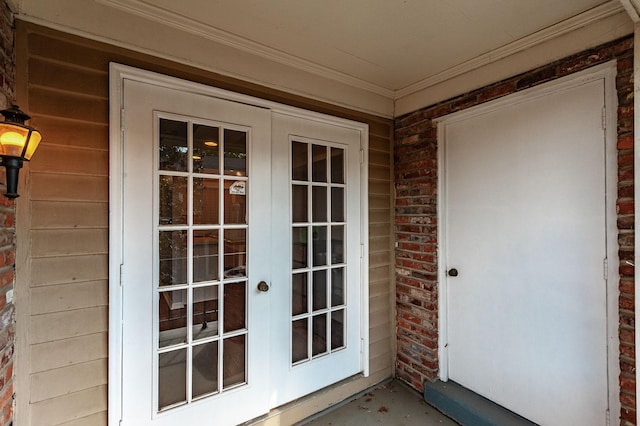 property entrance with brick siding and french doors