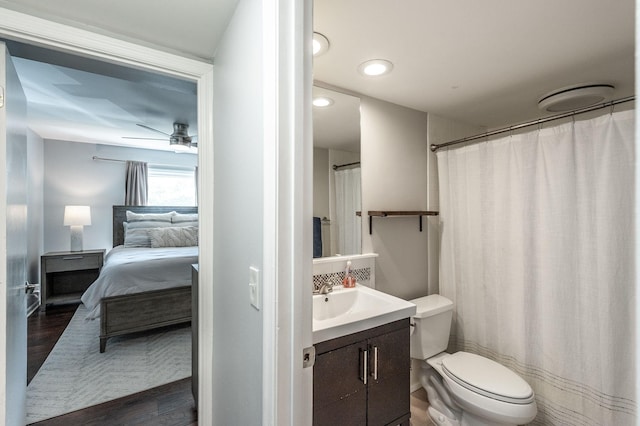 full bath with ensuite bath, wood finished floors, vanity, toilet, and recessed lighting