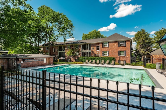 community pool featuring a patio area and fence