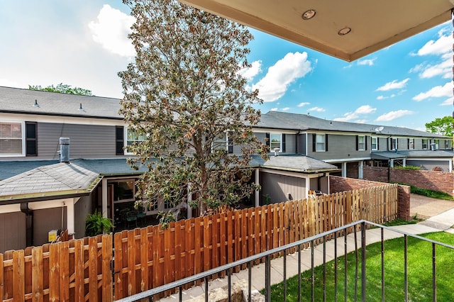 view of property featuring fence and a residential view
