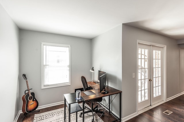 office space featuring visible vents, dark wood finished floors, and baseboards